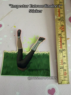 A pair of legs sticking straight up out of the grass, next to a ruler